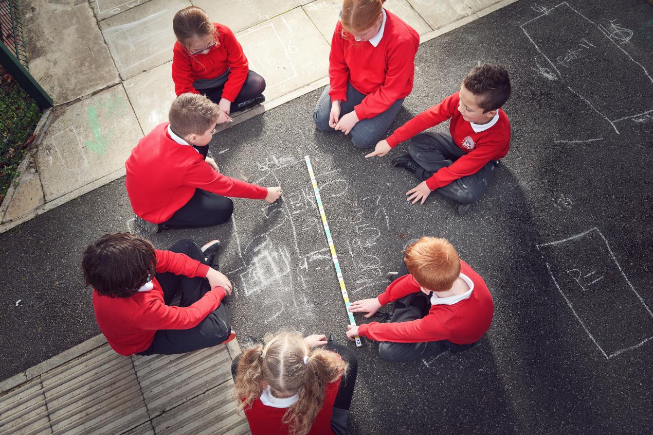 Half Acres pupils using chalk